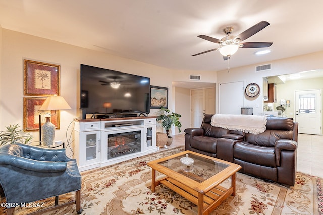 tiled living room with ceiling fan