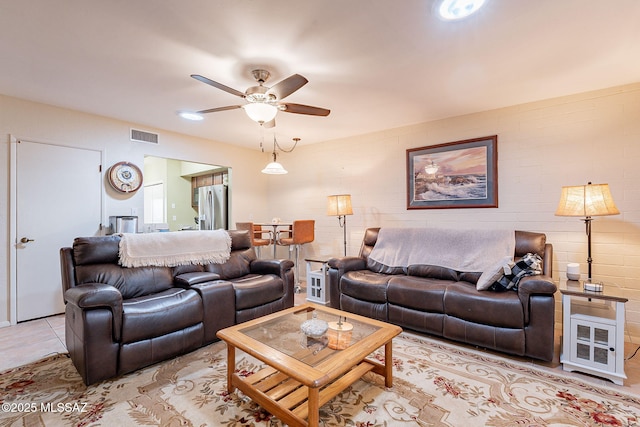 living room featuring light tile patterned flooring and ceiling fan