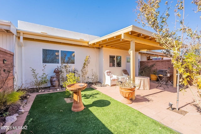 rear view of property with a yard and a patio area