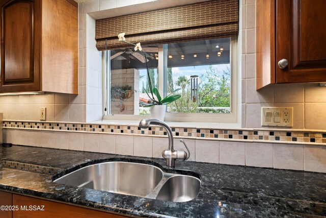 kitchen featuring visible vents, dark stone countertops, appliances with stainless steel finishes, and a sink