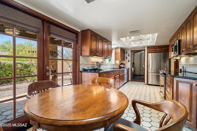 dining room featuring visible vents and a textured ceiling