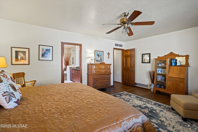 bedroom with baseboards, wood finished floors, a textured ceiling, and ceiling fan
