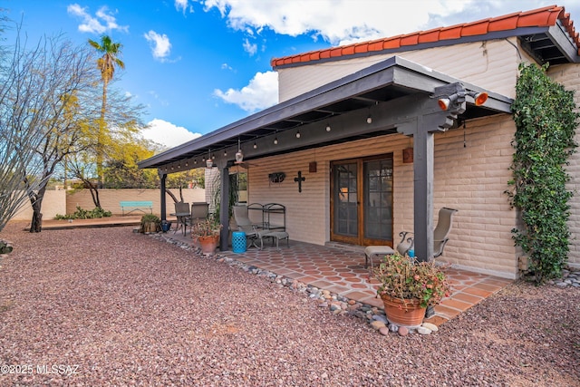 rear view of house featuring a patio area and fence