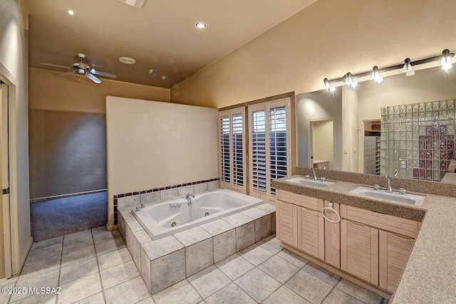 bathroom featuring a whirlpool tub, double vanity, a ceiling fan, and a sink