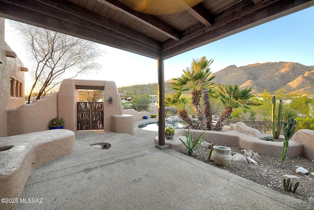 view of patio / terrace featuring a gate, fence, and a mountain view