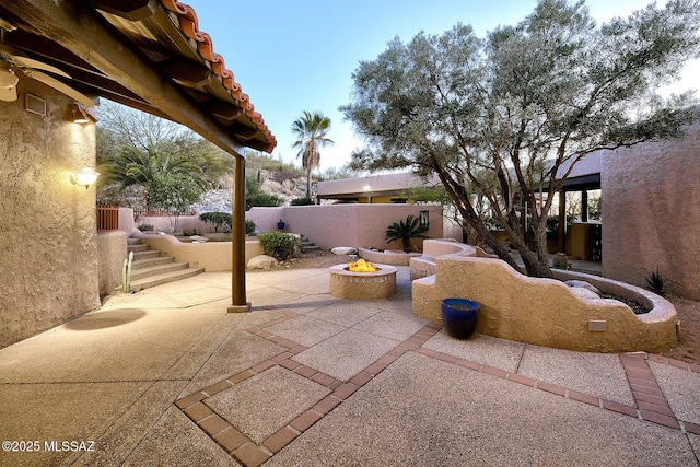 view of patio featuring an outdoor fire pit and a fenced backyard