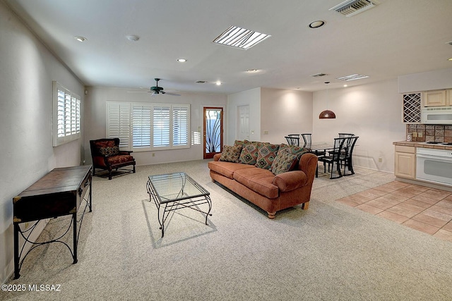 living area featuring recessed lighting, visible vents, light carpet, and light tile patterned floors