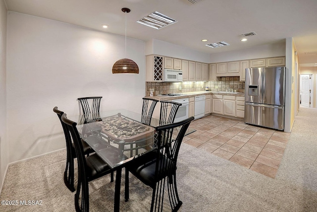 dining room featuring light carpet, visible vents, and recessed lighting