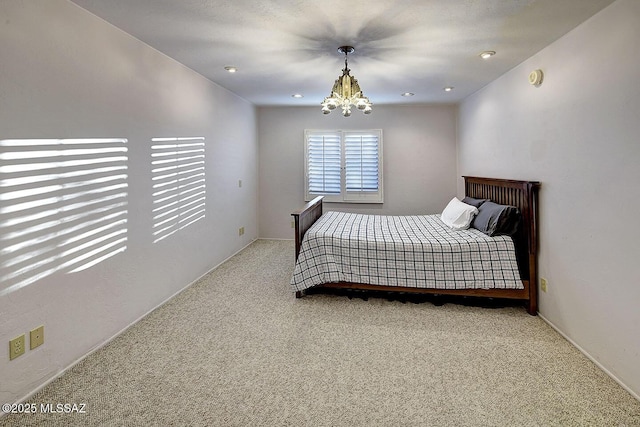 carpeted bedroom featuring a chandelier