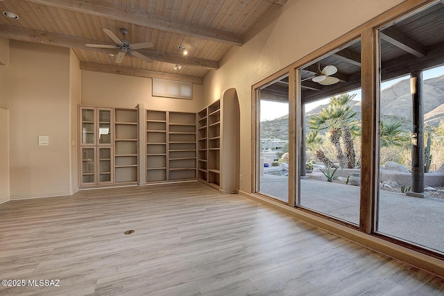 spare room with wooden ceiling, a wealth of natural light, wood finished floors, and beamed ceiling