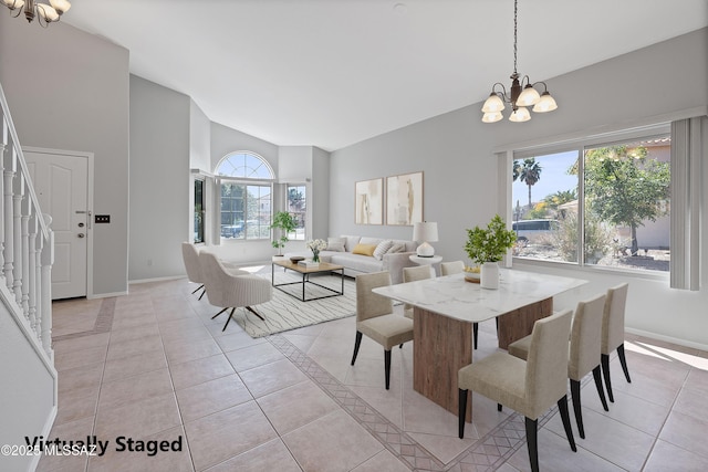 dining room with high vaulted ceiling, light tile patterned floors, and a chandelier