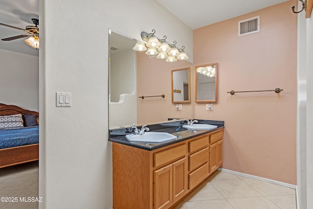 bathroom with tile patterned flooring, vanity, and ceiling fan