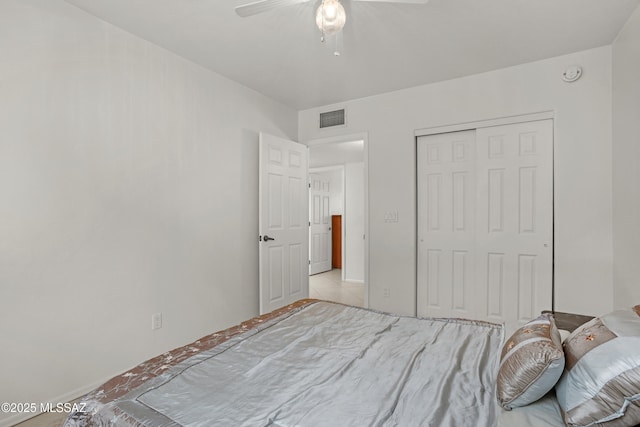 bedroom with ceiling fan and a closet