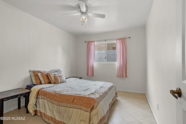 tiled bedroom featuring ceiling fan