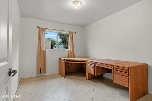 unfurnished office with light tile patterned floors