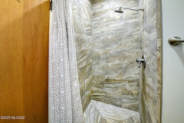 full bathroom featuring tiled shower