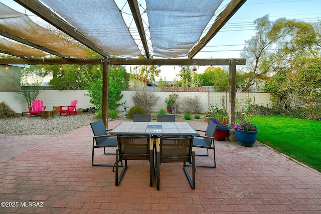 view of patio with outdoor dining space, a fenced backyard, and a pergola