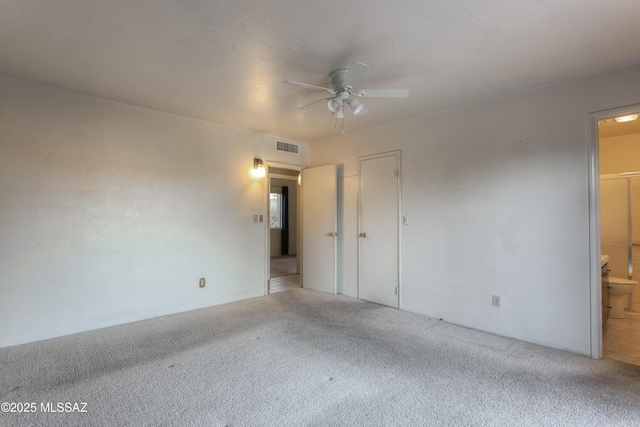 empty room with ceiling fan and light carpet