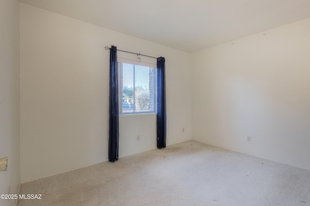 unfurnished room with light carpet