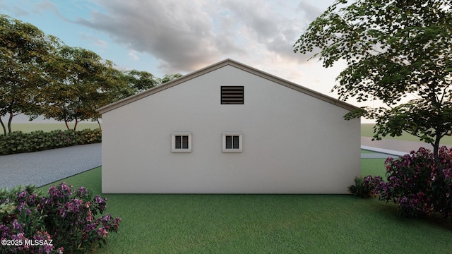 view of side of home with a lawn