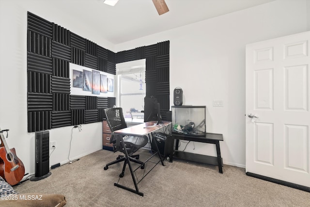 home office featuring light carpet and ceiling fan