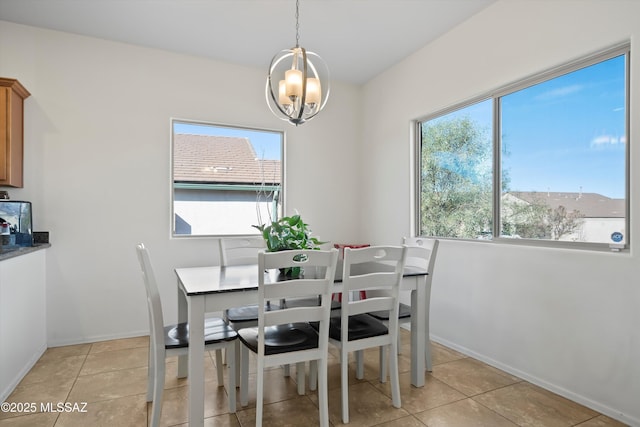 dining room with light tile patterned floors and a chandelier