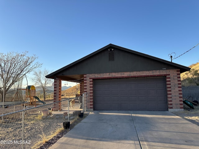 exterior space featuring a garage and a playground