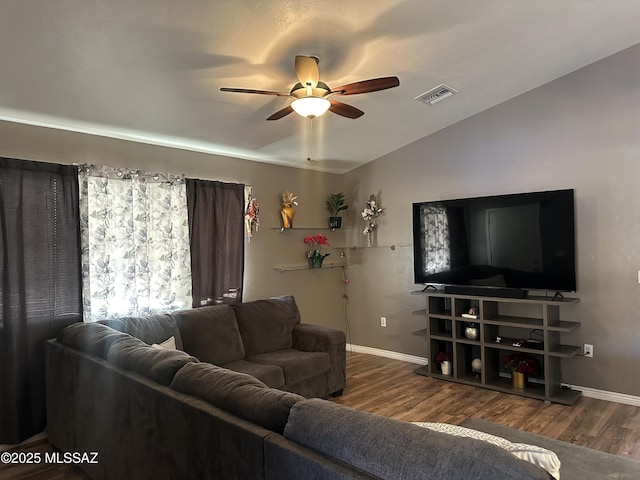 living room with ceiling fan, vaulted ceiling, and wood-type flooring