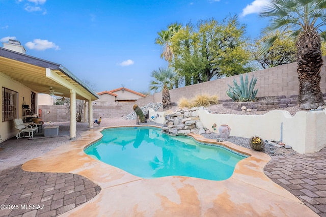 view of pool featuring ceiling fan and a patio area