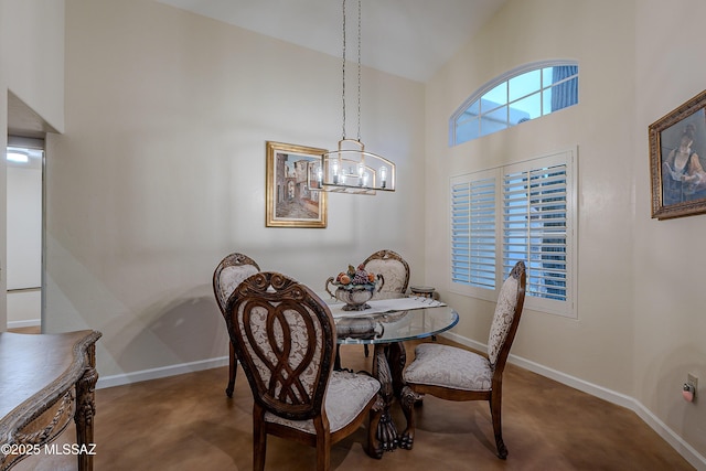 dining room featuring a towering ceiling