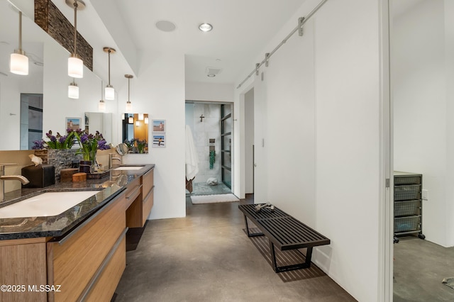 bathroom with a shower stall, concrete floors, and a sink