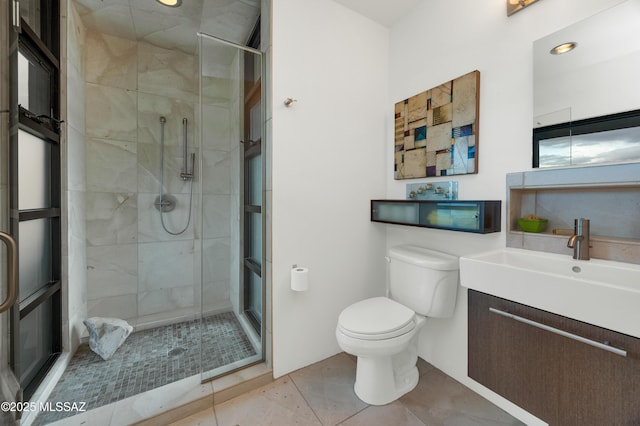 full bath with toilet, tile patterned floors, a shower stall, and vanity