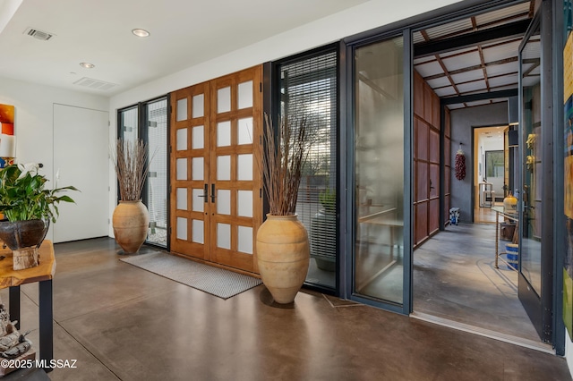 entryway featuring recessed lighting, french doors, visible vents, and finished concrete flooring