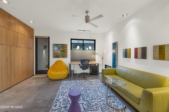 interior space featuring concrete flooring, a ceiling fan, and recessed lighting