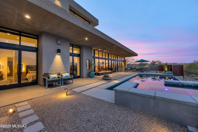 view of pool featuring an outdoor hangout area, a patio area, and a fenced in pool