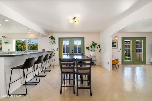 tiled dining area featuring french doors