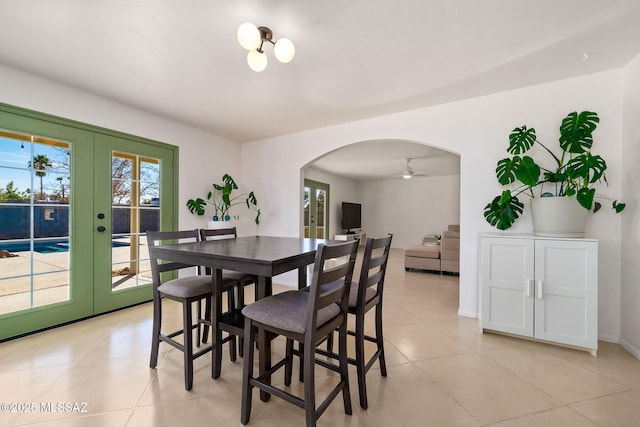 dining area featuring light tile patterned floors and french doors