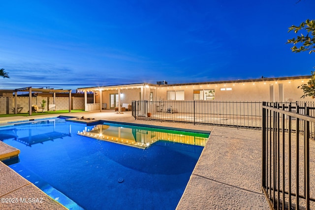 pool at dusk with a patio