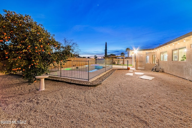 playground at dusk featuring a fenced in pool