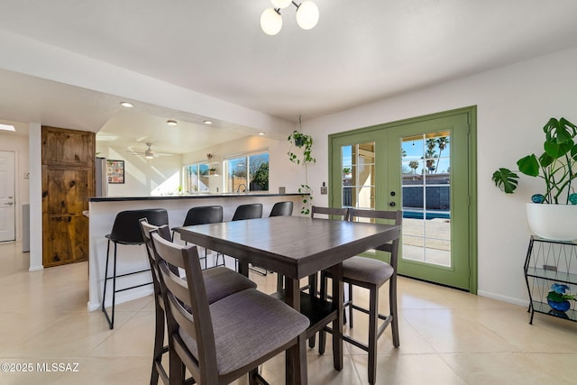 dining room with french doors and light tile patterned floors