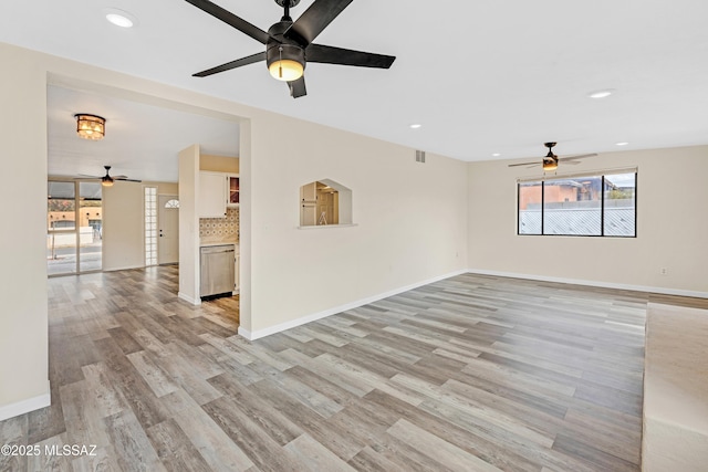 unfurnished living room with ceiling fan and light hardwood / wood-style flooring