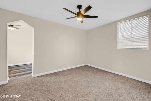 spare room with lofted ceiling, carpet flooring, and ceiling fan