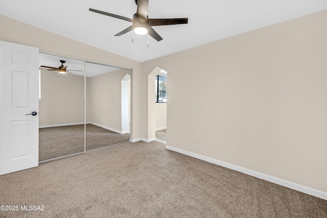 unfurnished bedroom with carpet, ceiling fan, and a closet