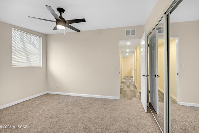 carpeted empty room featuring ceiling fan