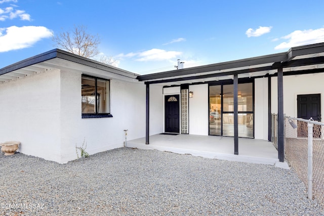 entrance to property featuring a patio area