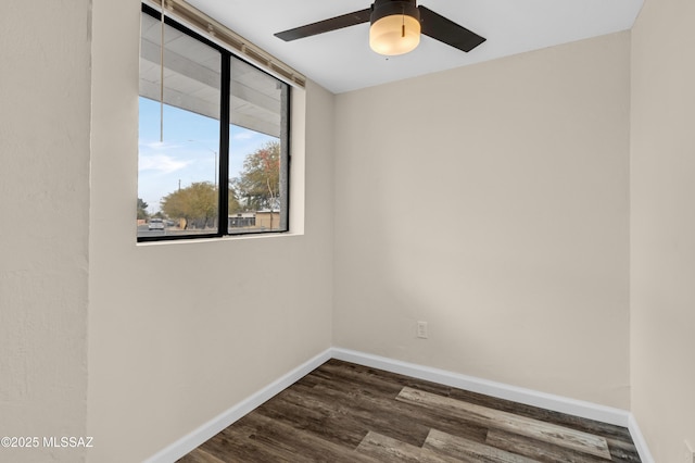 empty room with ceiling fan and dark hardwood / wood-style flooring