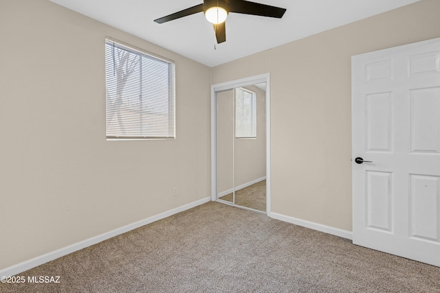 unfurnished bedroom with light colored carpet, ceiling fan, and a closet