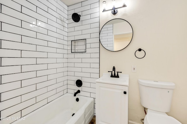 full bathroom with vanity, tiled shower / bath combo, and toilet