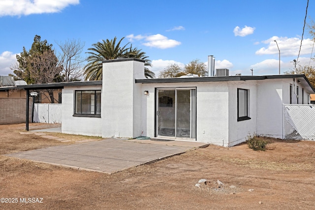 back of property with a patio