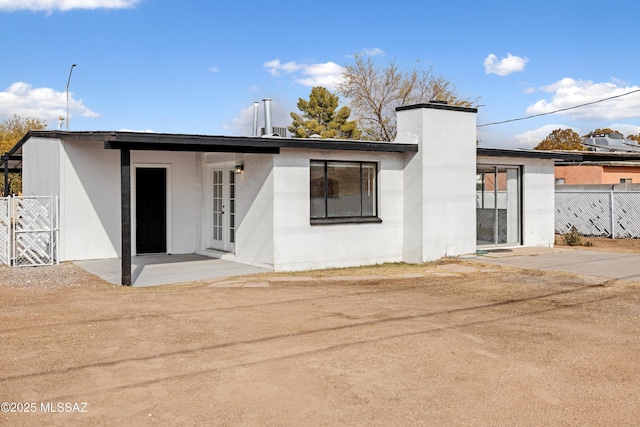 back of property with a patio